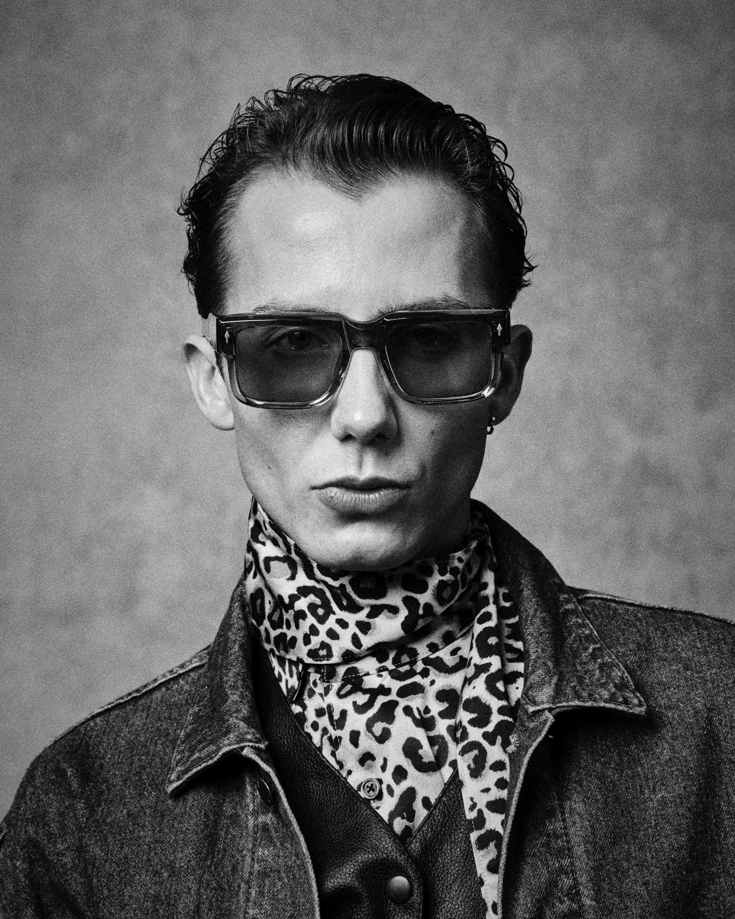Model wearing Jacques Marie Mage Hemmings sunglasses with bold rectangular acetate frame and tinted lenses. Available at WINK Optometrists