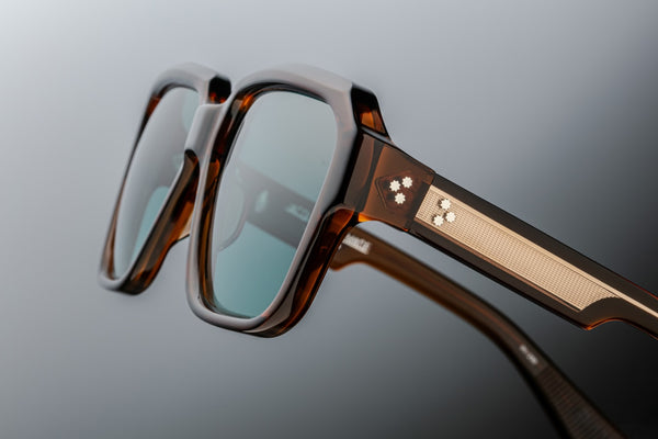 Close-up of Jacques Marie Mage Alfred Hickory glasses showing intricate sculptural detailing, exposed core wire, and premium acetate finish