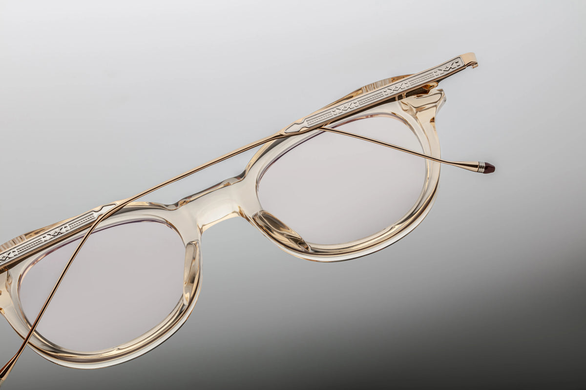 Interior macro close-up highlighting the backside mechanics of the Jacques Marie Mage Hisao Pearl. The translucent acetate allows a clear view of the custom light-gold tension-secured hairline monoblock hinge. The inner arm cleanly displays the debossed gold-leaf stamp indicating "MADE IN JAPAN" alongside the unique individual limited edition serial number