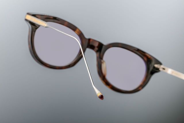 Profile view of the Jacques Marie Mage Hisao RX Havana frame. The thick tortoiseshell acetate front transitions into sleek, custom silver titanium temples. The metal temples feature intricate, finely engraved Native-inspired horizontal line detailing, culminating in custom temple tips accented with dark burgundy bordeaux epoxy tips.
