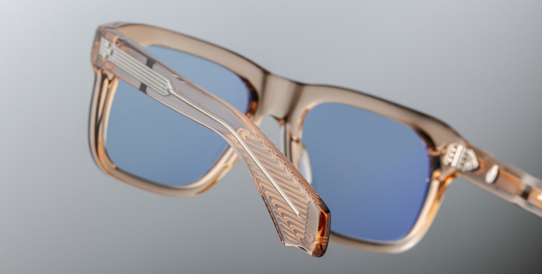 Inspired by Yves Saint Laurent, a French fashion designer. An Icon of JMM with soft angles and notable volumes. Clear tan 10mm cured cellulose acetate frame with custom double laminated acetate temples and blue lenses Limited edition of 350 pieces. Handcrafted in Japan Size 56/19. 