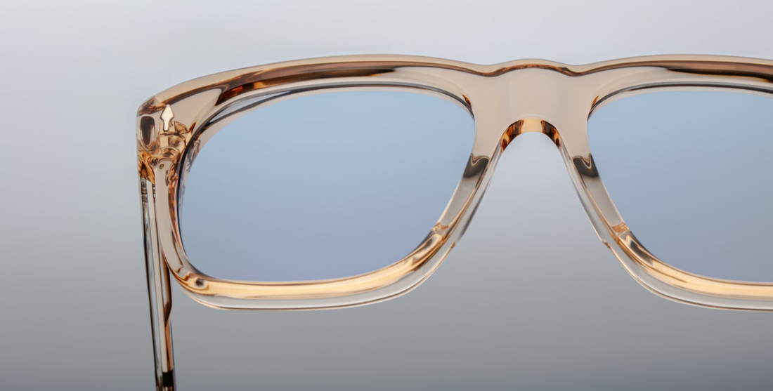 Inspired by Yves Saint Laurent, a French fashion designer. An Icon of JMM with soft angles and notable volumes. Clear tan 10mm cured cellulose acetate frame with custom double laminated acetate temples and blue lenses Limited edition of 350 pieces. Handcrafted in Japan Size 56/19. 