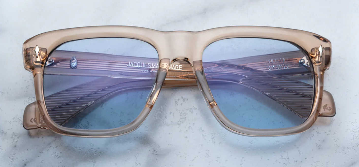 Inspired by Yves Saint Laurent, a French fashion designer. An Icon of JMM with soft angles and notable volumes. Clear tan 10mm cured cellulose acetate frame with custom double laminated acetate temples and blue lenses Limited edition of 350 pieces. Handcrafted in Japan Size 56/19. 