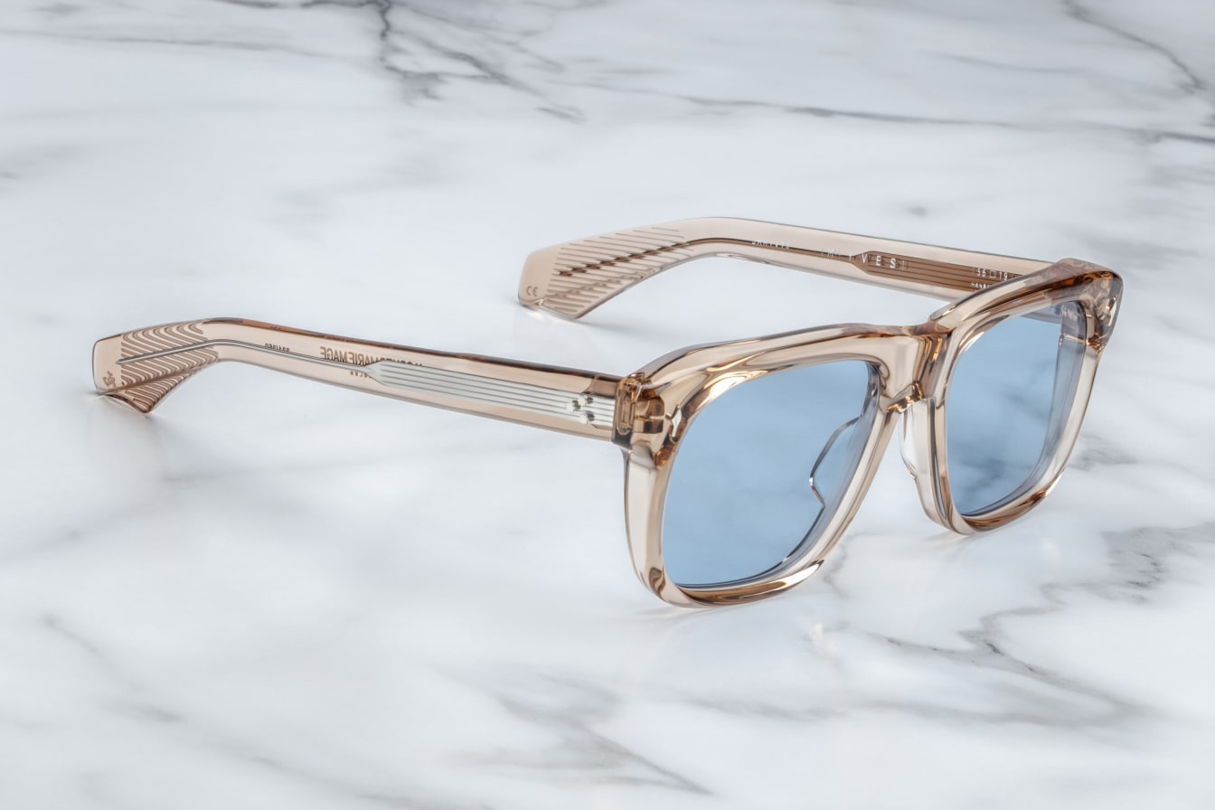 Inspired by Yves Saint Laurent, a French fashion designer. An Icon of JMM with soft angles and notable volumes. Clear tan 10mm cured cellulose acetate frame with custom double laminated acetate temples and blue lenses Limited edition of 350 pieces. Handcrafted in Japan Size 56/19. 