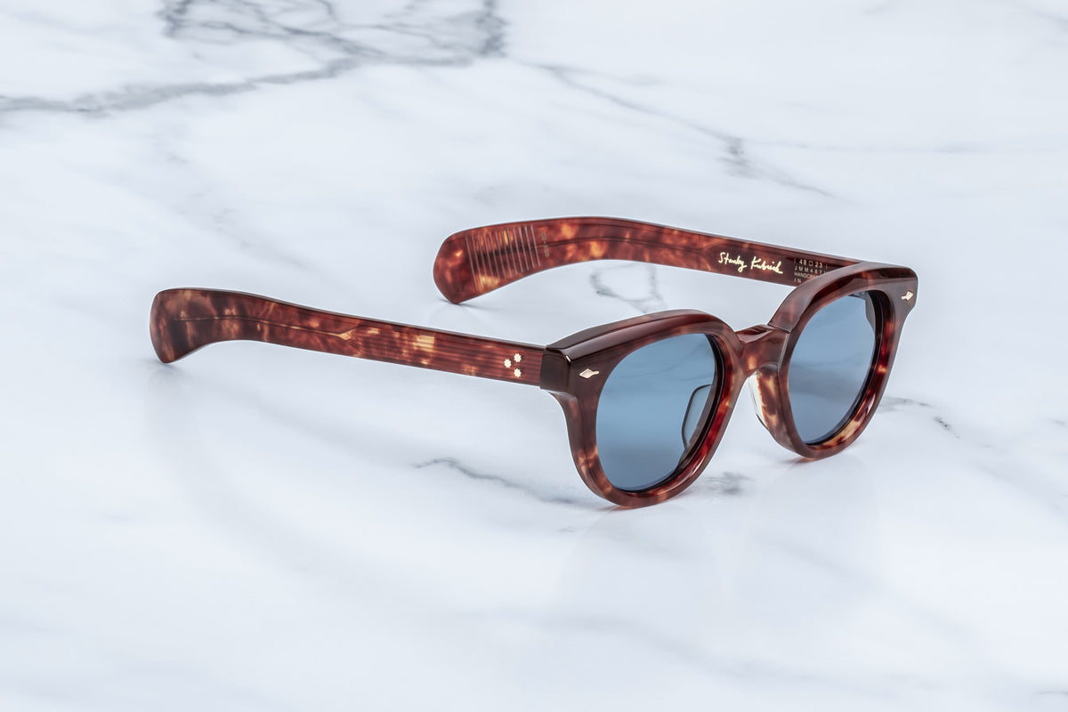 Full side profile of the Jacques Marie Mage 1948 Breccia frame. Displays the sculptural 10mm thick cured acetate construction along the temples, showcasing the double-laminated dark brown marbled acetate pattern and the gleam of the silver hardware rivets