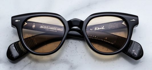 Front view of Jacques Marie Mage Stanley Kubrick 1948 sunglasses in Willow. Features a thick, mid-century rounded acetate frame in deep, translucent olive-toned Willow green, a robust keyhole bridge, signature sterling silver arrowhead front pins, and light sepia-tinted lenses.
