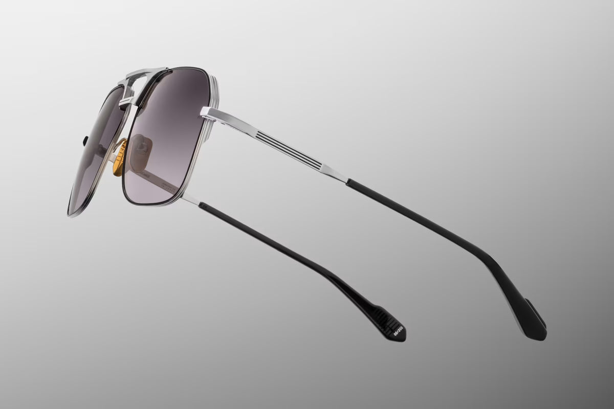 Close-up macro view of the hinge and chassis details on the JMM 1980 Silver frame. Highlights the precision-engineered silver palladium beta-titanium hardware, the intricate hairline border details hand-filled with black epoxy, and the premium custom internal hinge mechanism.
