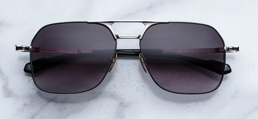 Front view of Jacques Marie Mage Stanley Kubrick 1980 sunglasses in Silver. Features a sleek, oversized aviator-style frame crafted from polished silver palladium beta-titanium with subtle black accents along the rims. Completed by a structural double nose bridge and dark armorlite jet gradient lenses.
