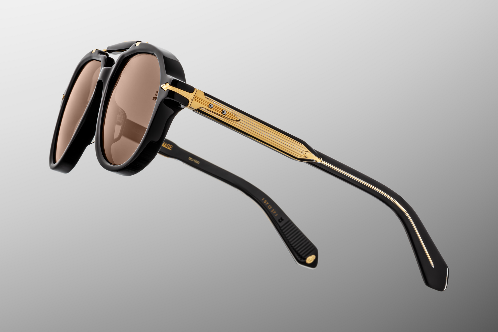 Detailed side close-up of Jacques Marie Mage 1991 Eclipse 2 sunglasses showing the custom 5-barrel hinge, hair-line engraved wire-core in the temple and layered acetate construction, available at WINK Optometrists.