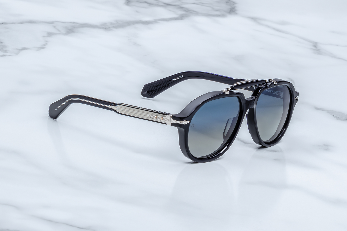 Side profile of Jacques Marie Mage Ayrton Senna 1991 Regal sunglasses, showcasing the clear-beige laminated temple with exposed wire-core detail and silver arrowhead end-piece, available at WINK Optometrists