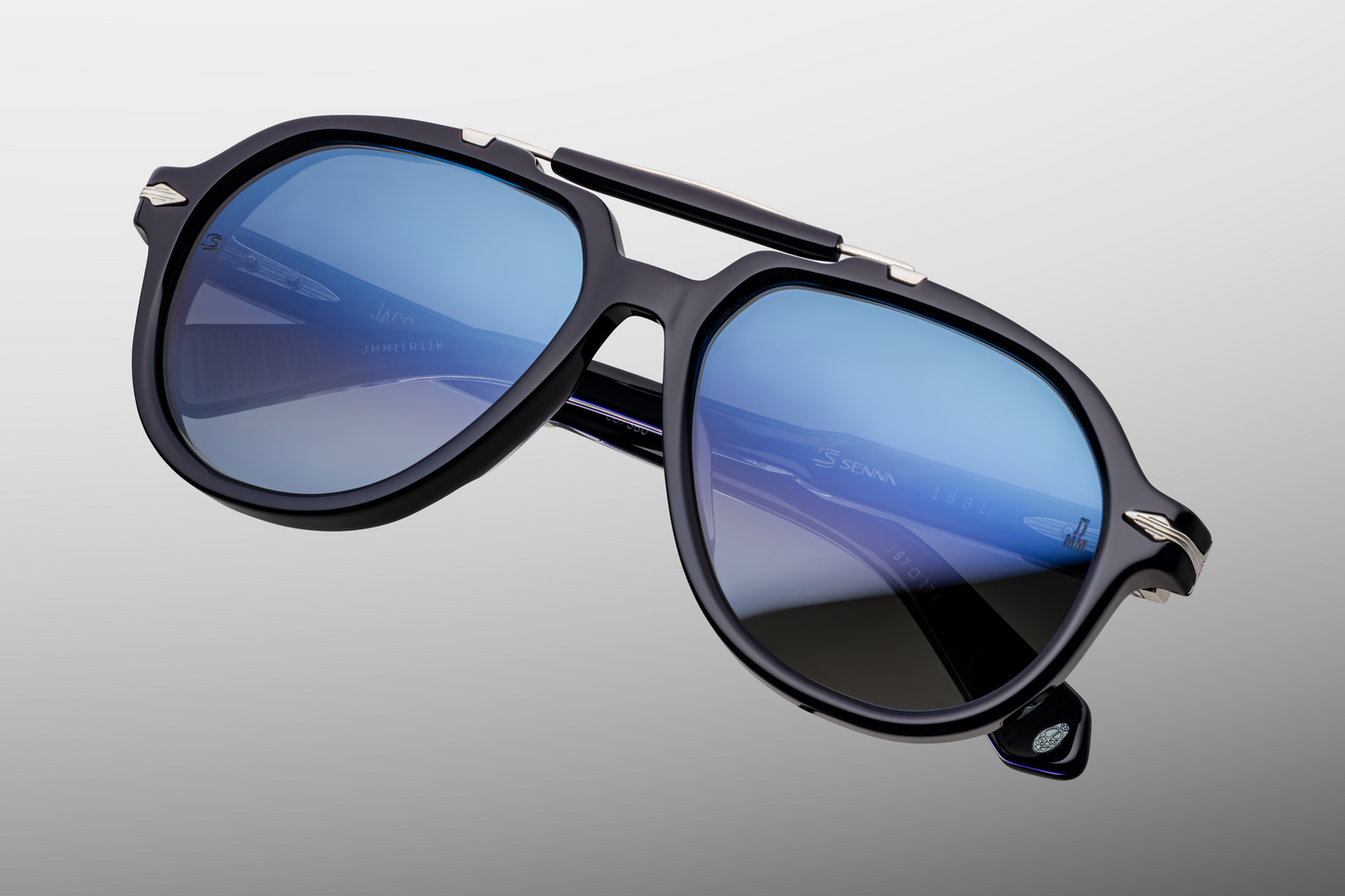 Close-up of front of Jacques Marie Mage Ayrton Senna 1991 Regal sunglasses highlighting the metal top-bridge accent, nose pads and rich brown crown-mineral lenses, available at WINK Optometrists