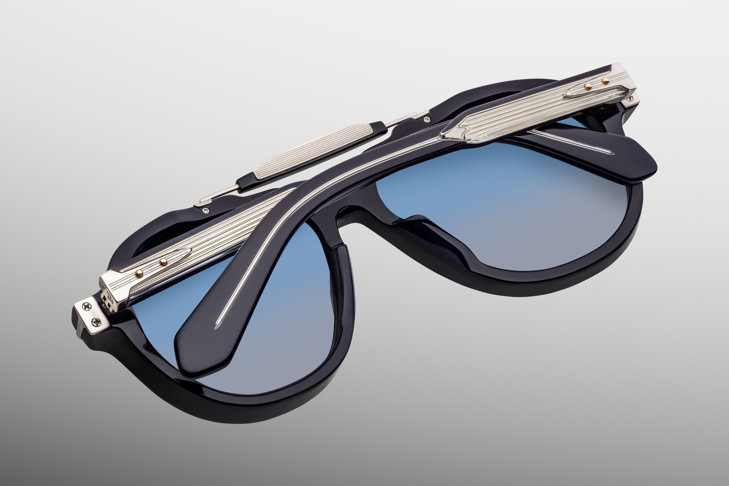 Back view of Jacques Marie Mage Ayrton Senna 1991 Regal sunglasses with temples folded in, revealing the foil-stamp limited-edition hallmarks on inner temple and polished black acetate frame interior, available at WINK Optometrists