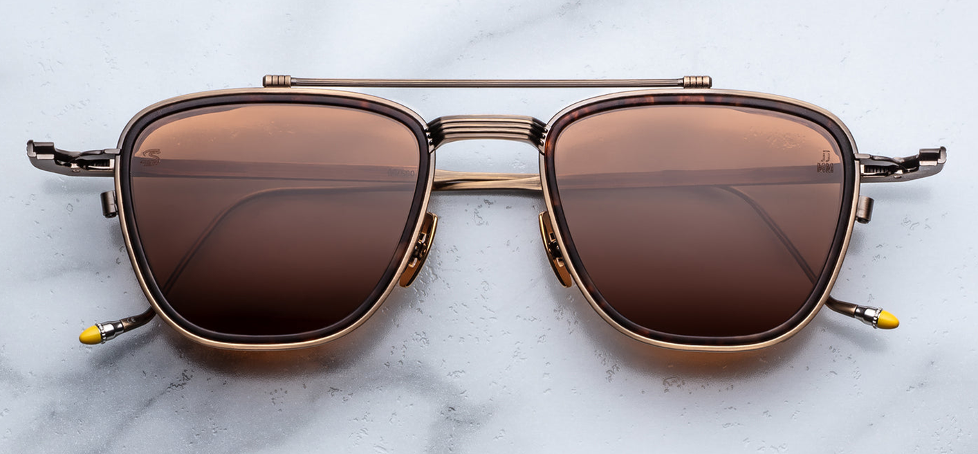 Front view of Jacques Marie Mage Ayrton Senna 1992 Antique Gold sunglasses showing bronze-hued beta-titanium pilot frame with matte agar acetate lens-rim inserts and warm pecan-brown crown-mineral lenses, available at WINK Optometrists