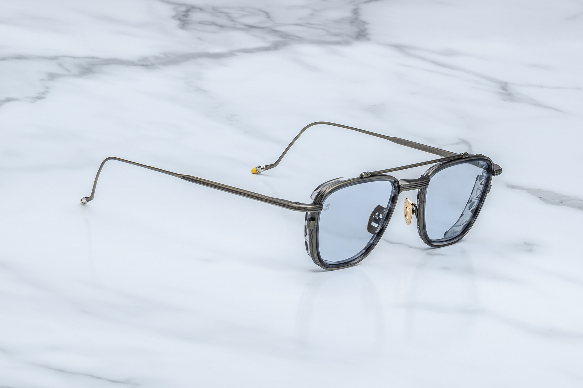 Side profile of Jacques Marie Mage Ayrton Senna 1992 Antique Gunmetal sunglasses showing the sleek temple in matte gunmetal beta-titanium with hand-painted yellow epoxy tip and polished silver palladium bezel, available at WINK Optometrists