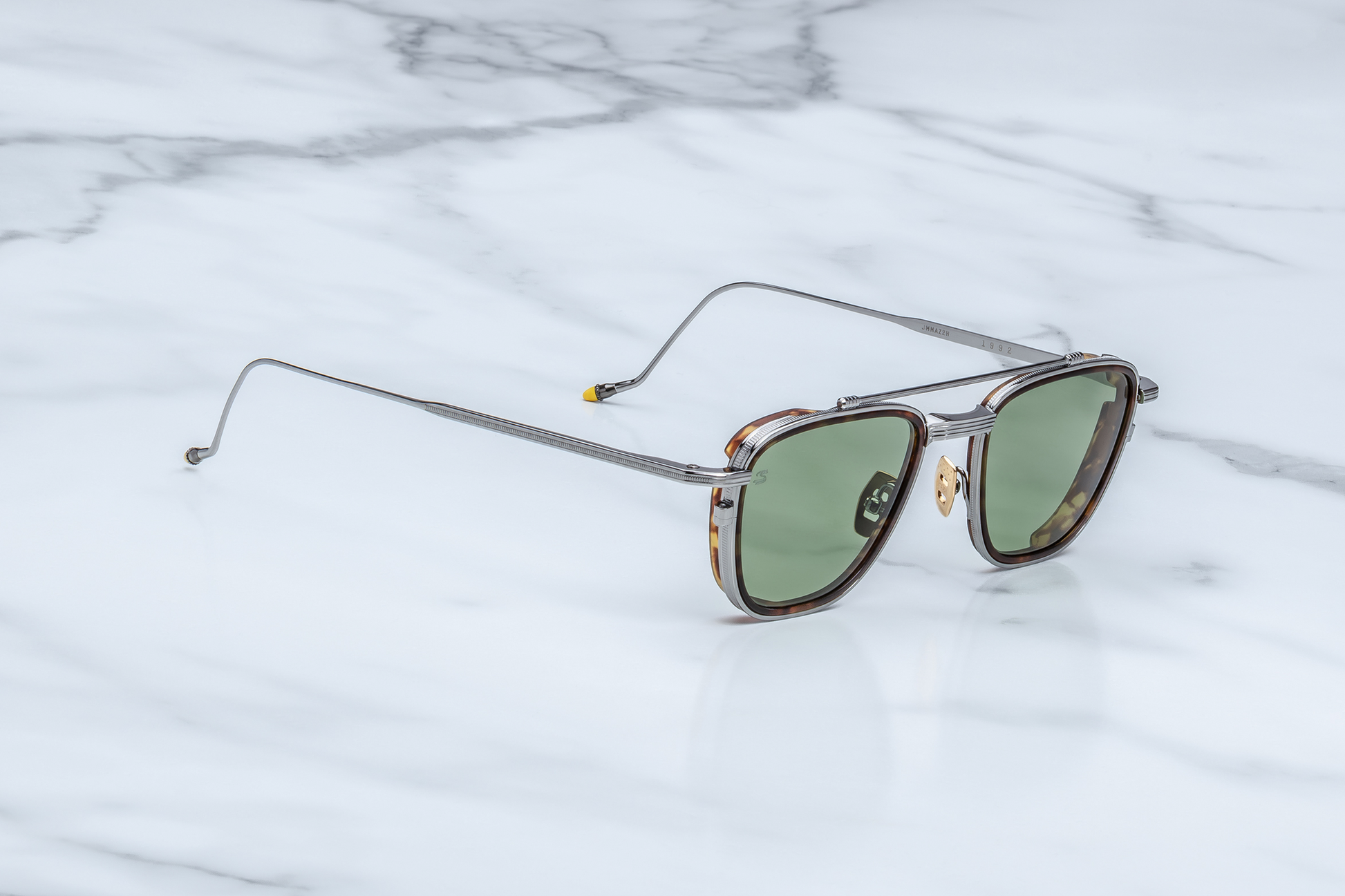 Side profile of Jacques Marie Mage 1992 Antique Silver sunglasses showcasing the slim temple in matte silver-beta-titanium, hair-line engraved finish and hand-painted yellow epoxy tip, available at WINK Optometrists