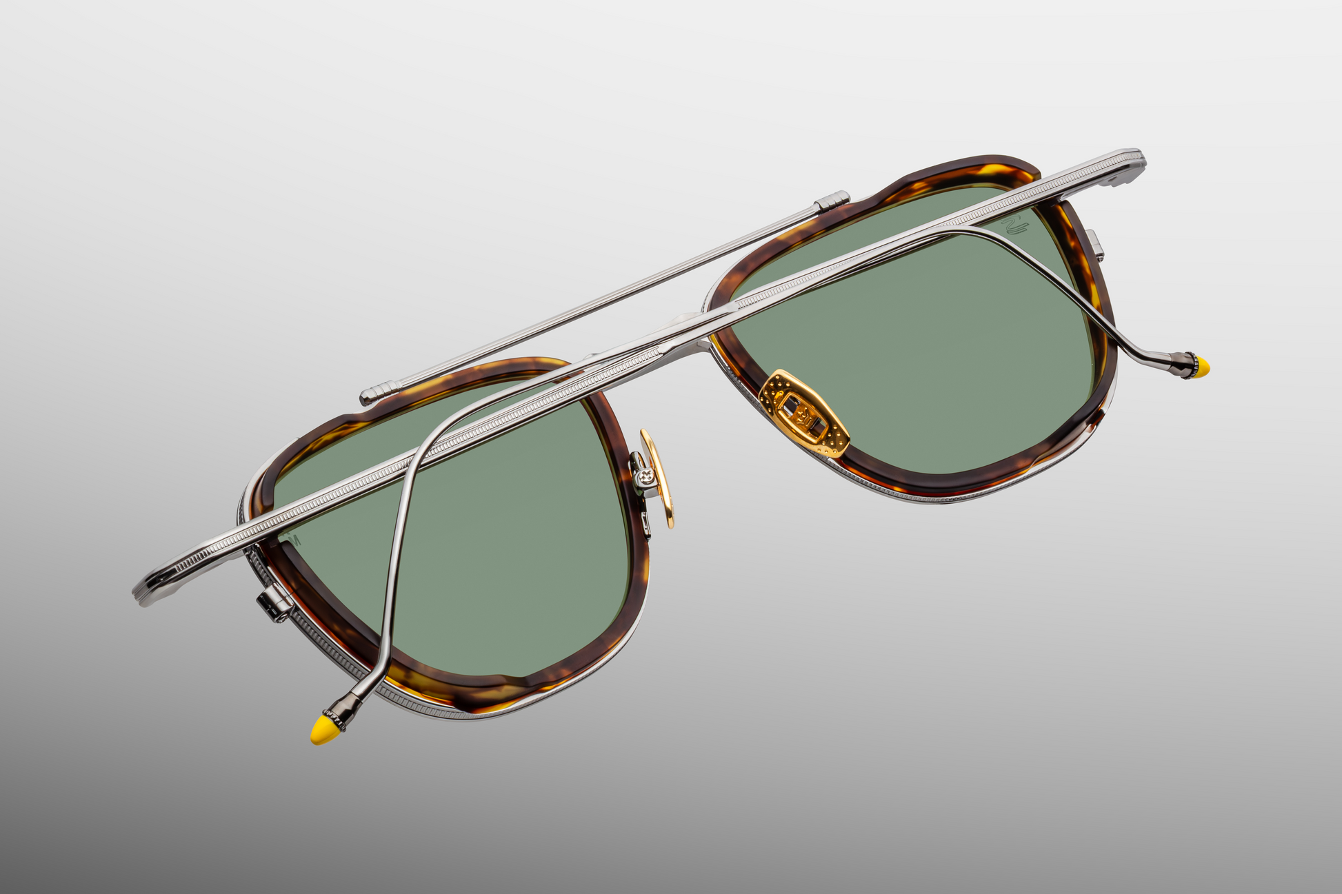 Back view of Jacques Marie Mage 1992 Antique Silver sunglasses with temples folded, revealing the inner temple foil-stamped limited-edition serial and polished matte silver-titanium interior finish, available at WINK Optometrists