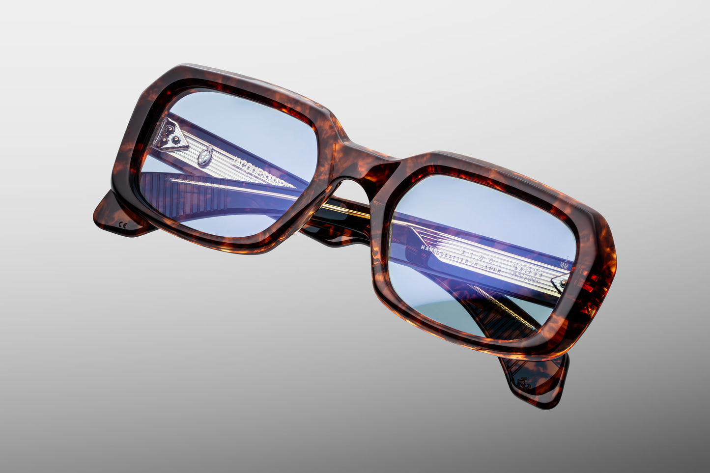 Top-down view of the JMM Aldo Argyle frame, revealing the deep structural geometry of the thick acetate brow, integrated nose contours, and custom dark gold 9-barrel hinges