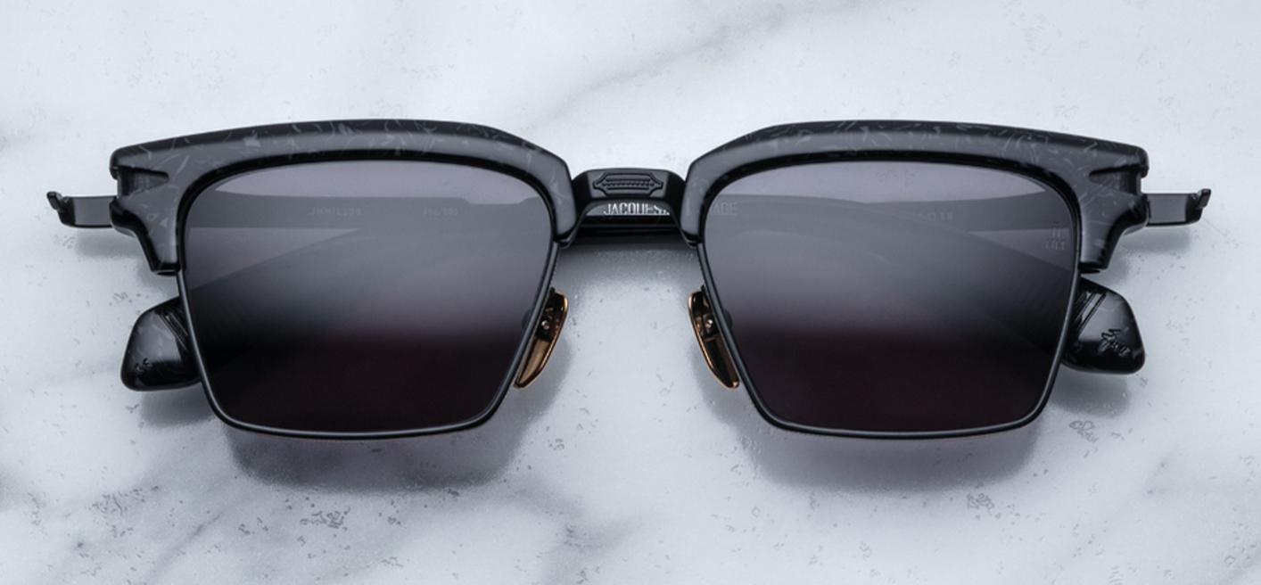 JMM Alin Slate" refers to the Alin model of glasses from the luxury eyewear brand Jacques Marie Mage, specifically in the Slate colorway. These eyeglasses, inspired by 1950s designs, feature a bold acetate brow, a titanium lens rim, and signature arrowhead detailing on the temples and hinge. They are known for their blend of vintage aesthetics and modern craftsmanship, with finely engraved temples and a distinct silhouette, making them a sought-after collectible for fans of high-end, retro-inspired eyewear.