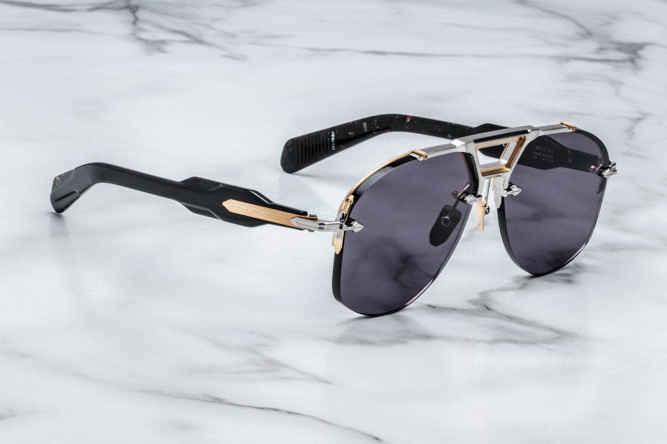 Rimless Series aviator sunglasses with dual-tone metal details, sculptural acetate temples, and blue titanium frame. Handcrafted in Japan.