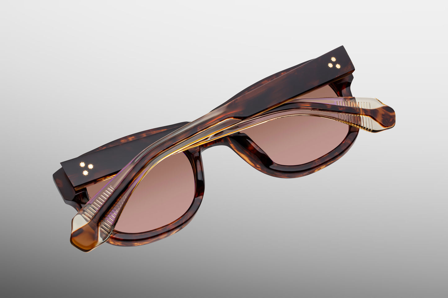 Rear perspective of the JMM Amilcar Argyle temples, highlighting the inner curved ear bends where the rich Havana exterior shifts to reveal a translucent clear beige inner laminate and the internal dark gold wirecore tip.