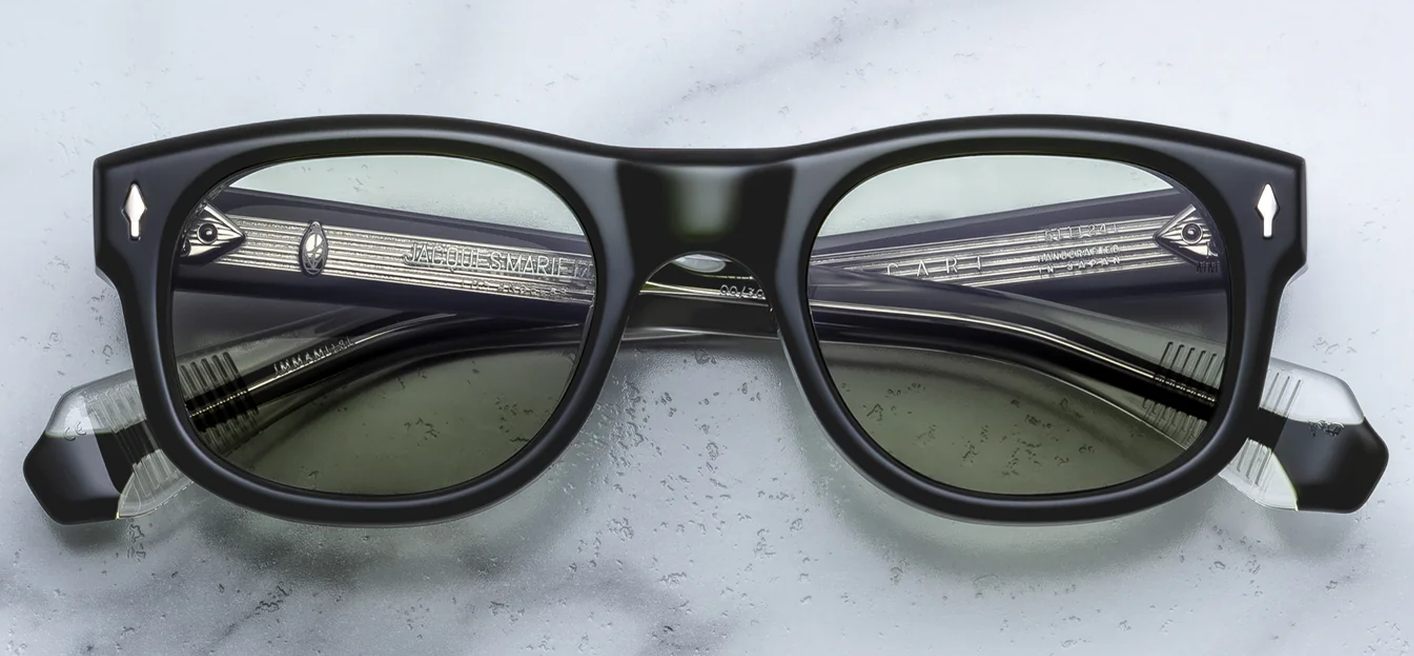 Front view of Jacques Marie Mage Amilcar sunglasses in Borneo olive-green acetate, showcasing classic round lenses with a softly arched brow line and signature sterling silver arrowhead pins.