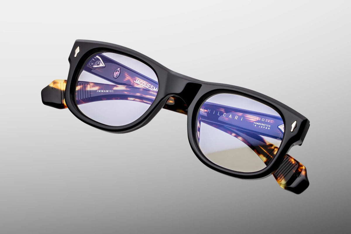 Top-down view of the Jacques Marie Mage Amilcar RX Noir eyeglasses, showcasing the imposing 10mm thickness of the front block acetate and the perfectly balanced alignment of the frame profile. From this angle, the hidden metal wire cores running through the inner Havana laminates are fully visible alongside the precision craftsmanship of the silver 7-barrel hinges. Available at WINK Optometrists