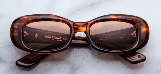 Jacques Marie Mage Ann Bourbon sunglasses front view, rectangular butterfly-inspired frame in warm havana acetate with dark Tuscan lenses
Front view of JMM Ann Bourbon glasses, medium-fit 90s rectangular silhouette in rich tortoise acetate with gold rivets