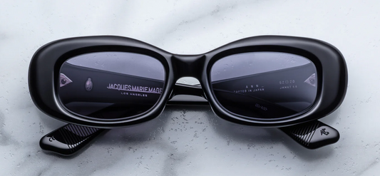Jacques Marie Mage Ann Raven sunglasses front view, rectangular black acetate frame with charcoal lenses and sculpted butterfly silhouette
Front view of JMM Ann Raven sunglasses, 90s-inspired rectangular frame in black acetate with silver arrowhead rivets