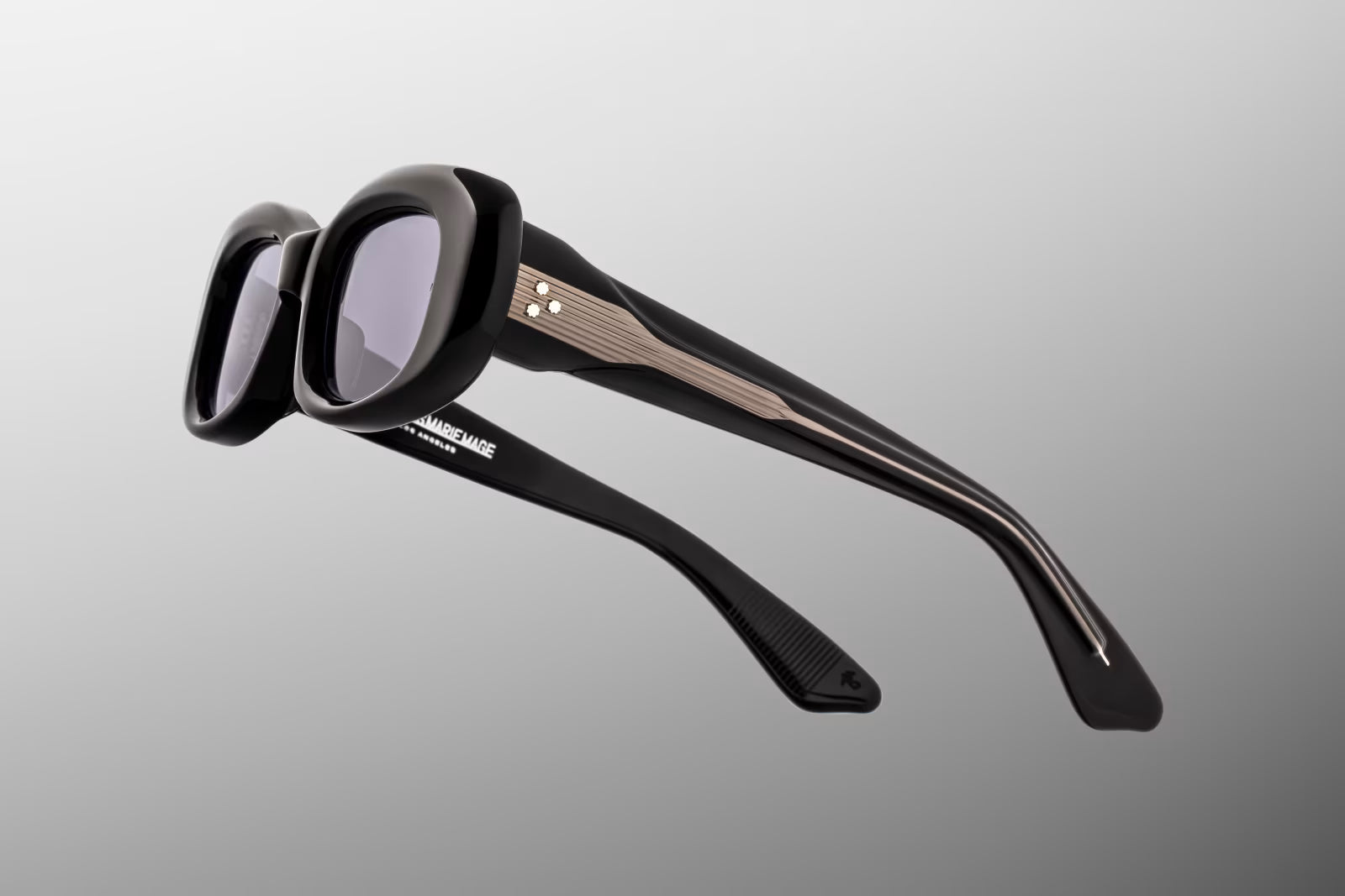 Close-up side detail of Jacques Marie Mage Ann Raven showing engraved wirecore, custom 7-barrel hinge and layered acetate temples
Macro side view of JMM Ann Raven sunglasses highlighting premium hardware and temple construction