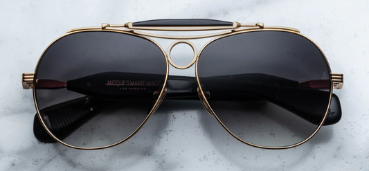 Front view of Jacques Marie Mage Aspen Gold/Black glasses featuring bold rectangular frame with gold and black titanium accents