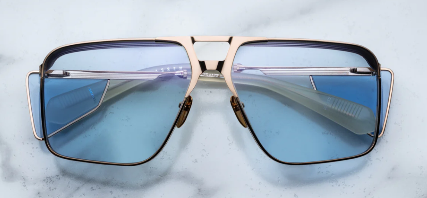 Front view of Jacques Marie Mage Assen sunglasses in Altan, featuring a refined square frame and warm amber-brown acetate, available at WINK Optometrists.