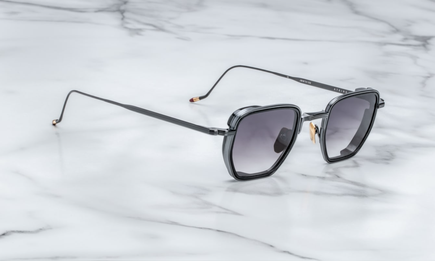 Side profile of Jacques Marie Mage Atkins in Slate showing sculpted temples, signature silver arrowhead hinge, and matte grey finish, available at WINK Optometrists.