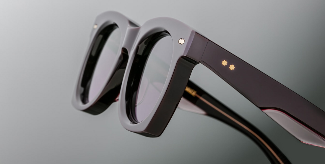 Sleek '50s inspired glasses with graceful lines, signature double-arrowhead front pins, and custom double-laminated temples with refined 'Lever' wire core. Purple 8mm cured cellulose acetate frame with custom double laminated acetate temples featuring precious metal hardware and primary purple gradient lenses. Light gold double-arrowhead front pin Inner light gold lever wirecore Light gold tension-secured custom ball hinge Aubergine CR39 4 base lenses with backside anti-reflective treatment 100% UV Protecti