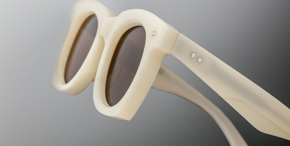 The ‘Ava’ is a sleek '50s inspired glasses with graceful lines, signature double-arrowhead front pins, and custom double-laminated temples with refined 'Lever' wire core. White 8mm cured cellulose acetate frame with custom double laminated acetate temples featuring precious metal hardware and primary brown lenses. Limited edition of 150 pieces. Handcrafted in Japan. Size 45/24. 