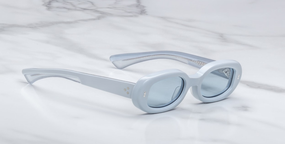 Angled view of Besset Sky Suede eyewear in soft pastel finish, highlighting subtle oval shape, polished interior, and delicate metallic hardware on temples.