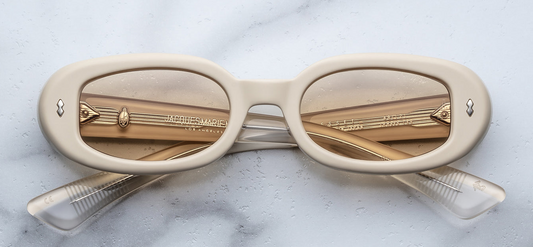 Front view of Jacques Marie Mage Besset Sun Suede in matte pastel yellow cellulose acetate—’90s-inspired petite oval shape with signature arrowhead front pins and minimalist matte textured finish.