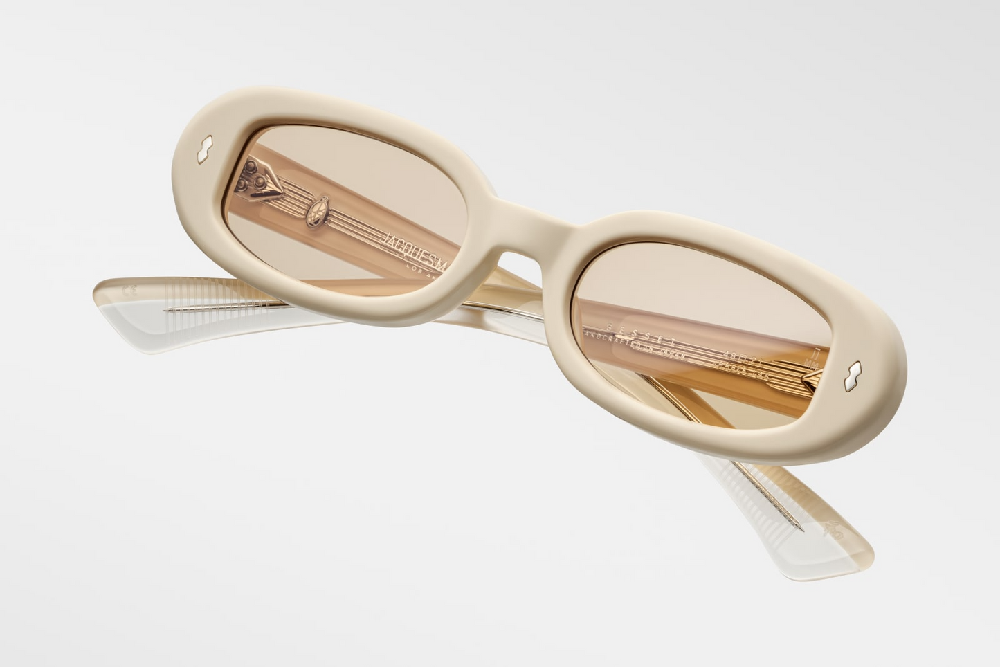 Angled downward view of Besset Sun Suede—featuring matte suede-style pastel yellow frame, Mode Yellow Armorlite lenses with backside anti‑reflective coating, oval ’90s silhouette, and limited-edition artisanal texture.