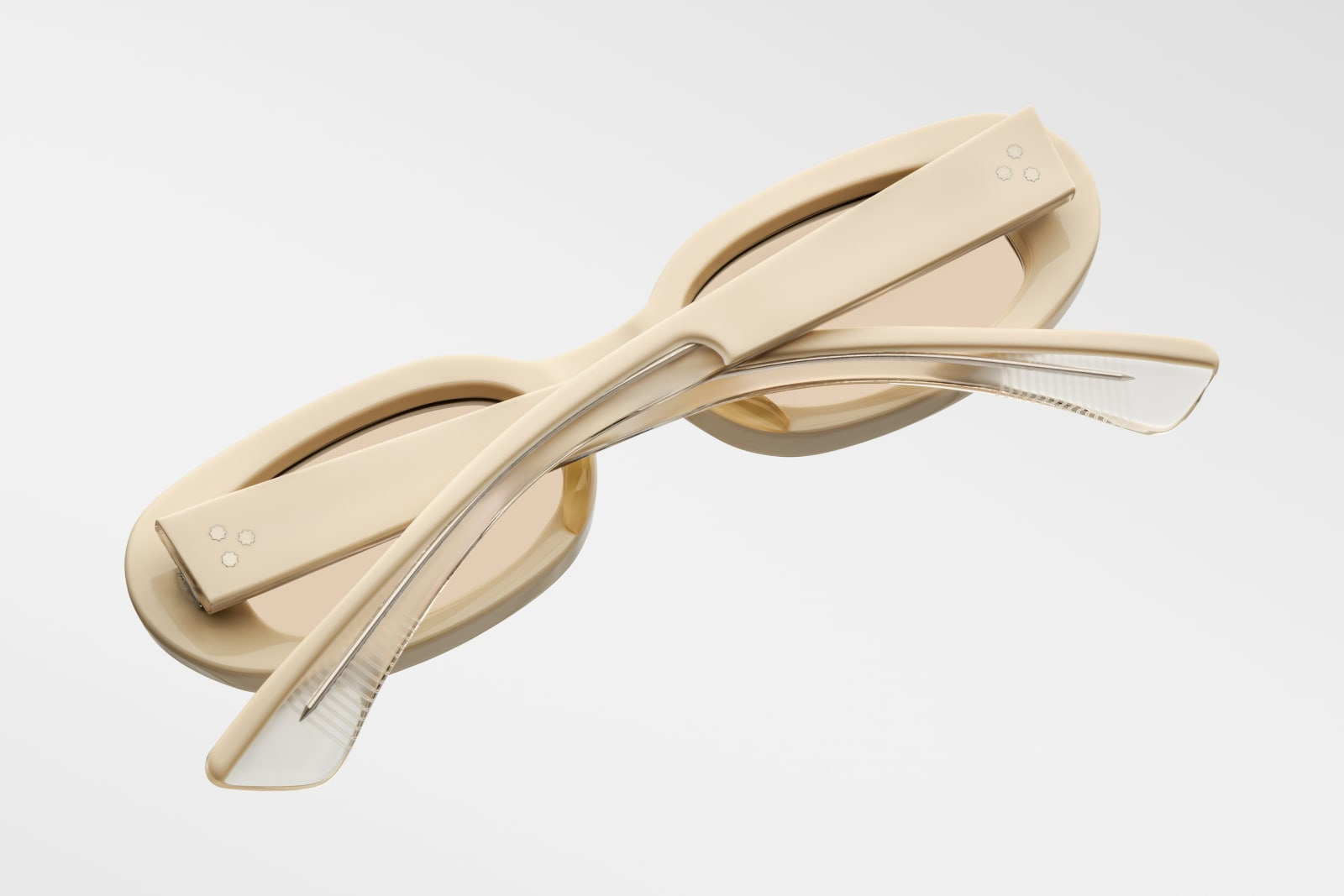 Close-up side view of Jacques Marie Mage Besset Sun Suede temple—8 mm cured yellow cellulose acetate, custom double-laminated temple, silver lever wirecore, tension-secured 7-barrel hinge, and signature arrowhead rivets.