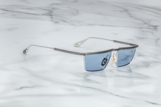 Side profile of Jacques Marie Mage Bogart in Gris showing sculpted temples, signature metal hinges, and polished grey finish, available at WINK Optometrists.
