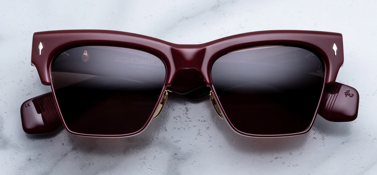 Front view of Jacques Marie Mage Bugsy Bordeaux Empire sunglasses. Displays a premium semi-rimless mid-century combo frame with a bold 10mm deep wine-red acetate brow line, polished silver palladium titanium eye rims with Bordeaux epoxy details, and solid deep brown lenses.