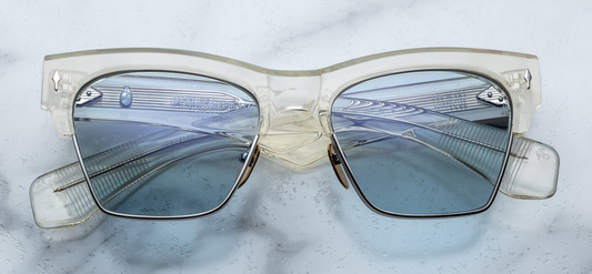 Front view of Jacques Marie Mage Bugsy Brut—mid‑century clubmaster sunglasses with silver beta titanium rim, crystal‑clear acetate brow, Blue Bird CR‑39 lenses, and silver arrow‑head front pin