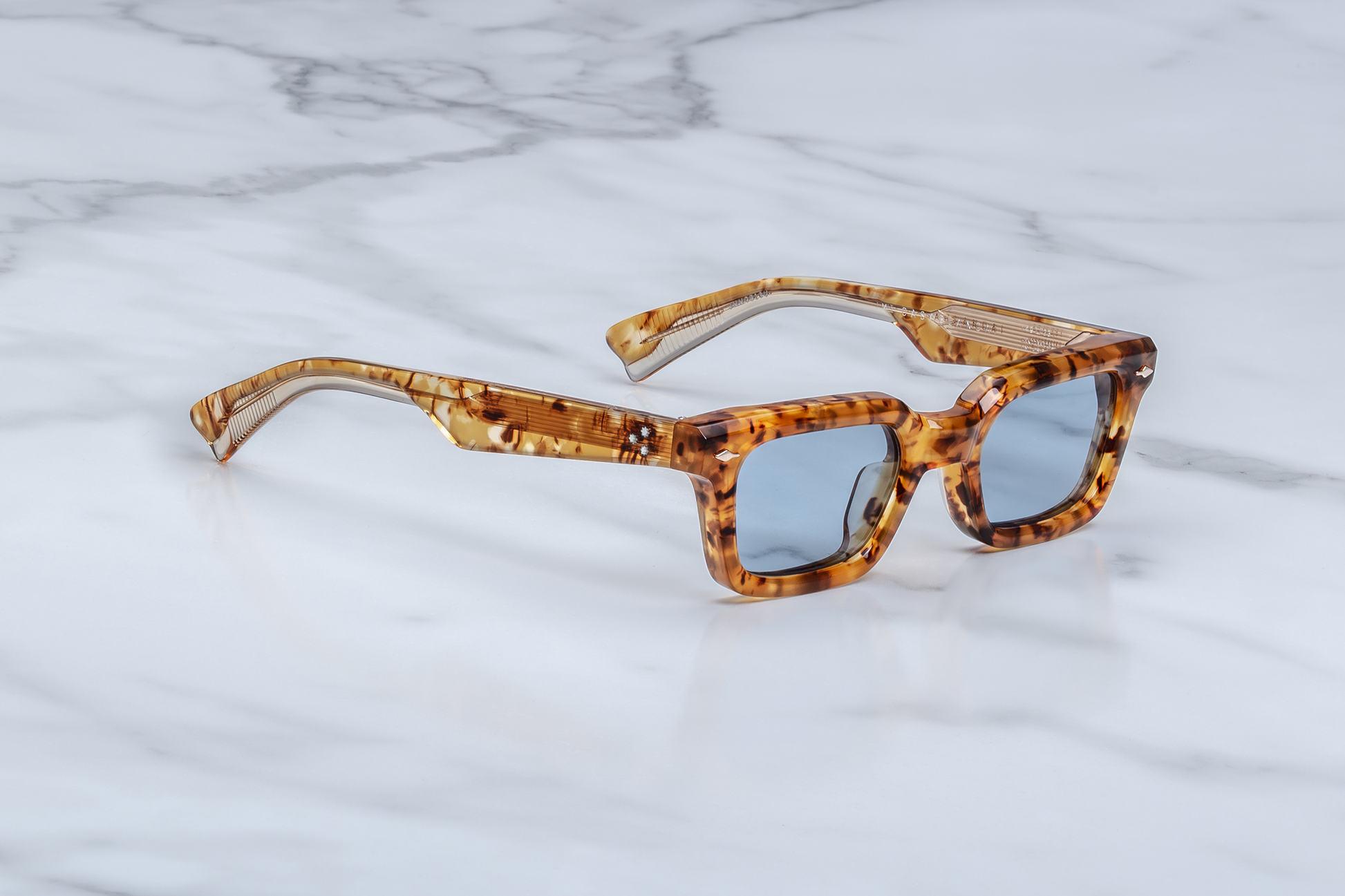 Side profile of Jacques Marie Mage Casablanca in Cairo showing sculpted temples, signature metal hinges, and layered brown acetate finish, available at WINK Optometrists.