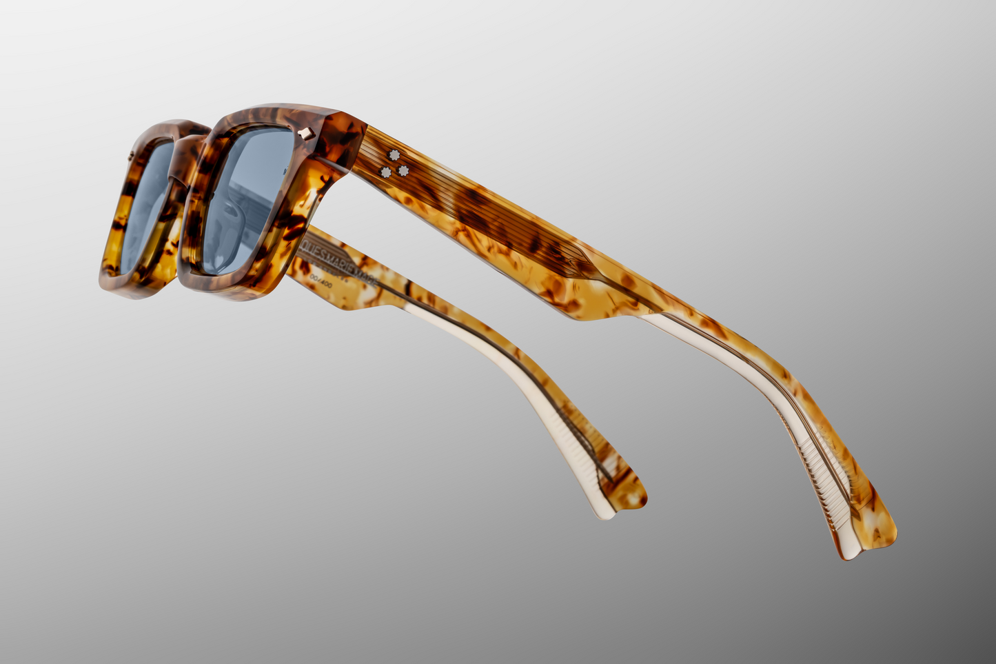 Temple detail of Jacques Marie Mage Casablanca in Cairo showing engraved JMM emblem, precision hinge design, and layered brown acetate, available at WINK Optometrists.