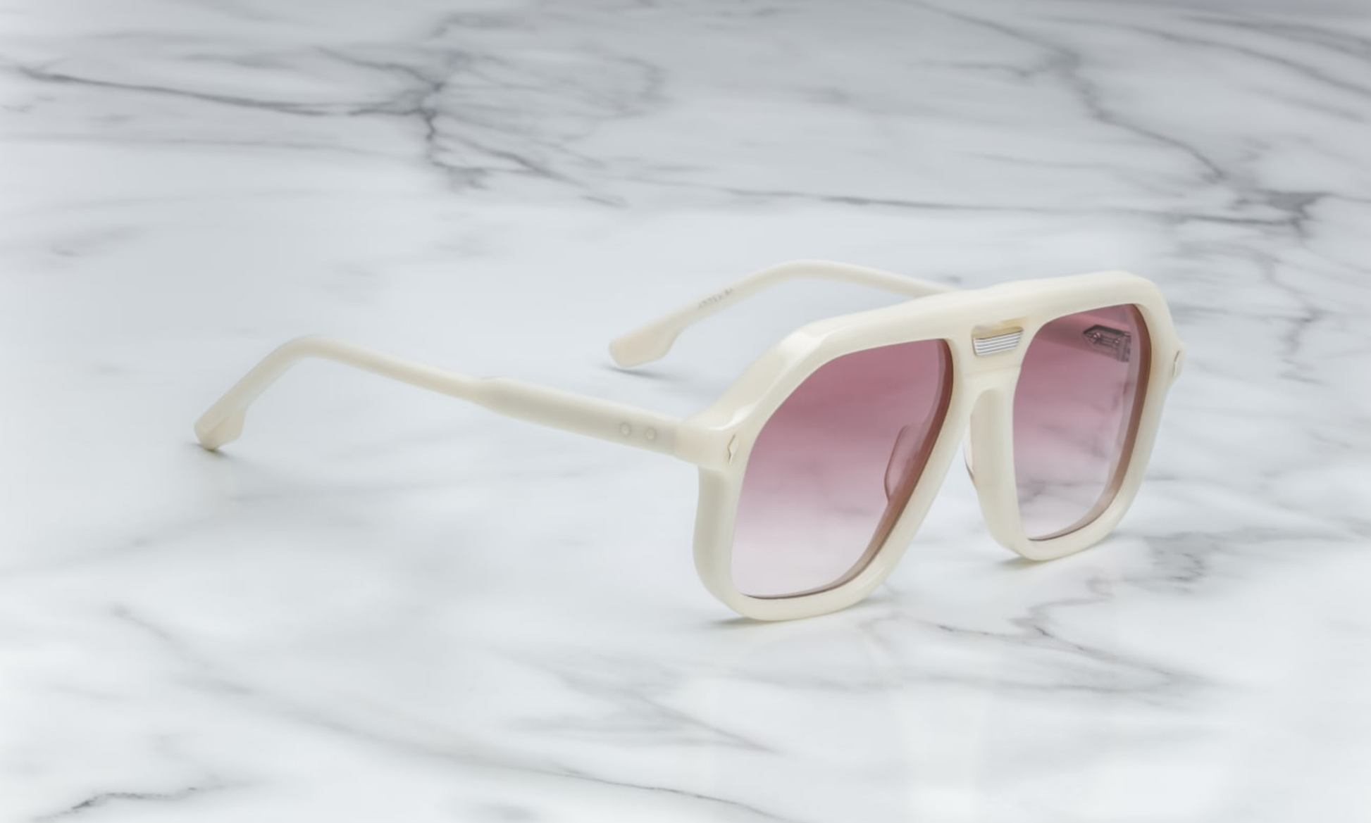 Side view of Jacques Marie Mage Casius Lotus sunglasses, showcasing the sleek, angular silhouette of the oversized frame. The design highlights the delicate gold-tone metal accents along the temples and the high-end craftsmanship. The lenses are dark and slightly curved, contributing to the bold yet refined aesthetic of the sunglasses