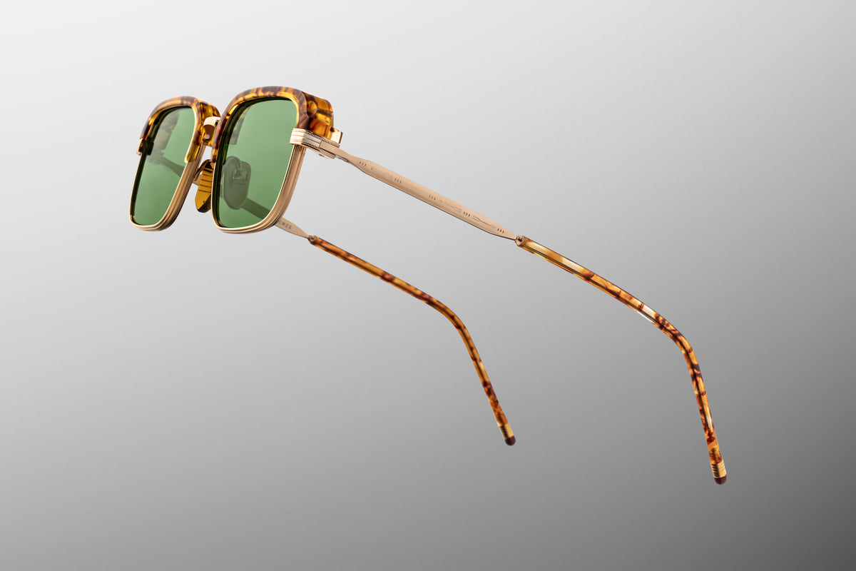 Side profile of Jacques Marie Mage Comanche eyeglasses, highlighting the light gold beta titanium temples intricately engraved with tribal-inspired filigree and arrowhead motifs.