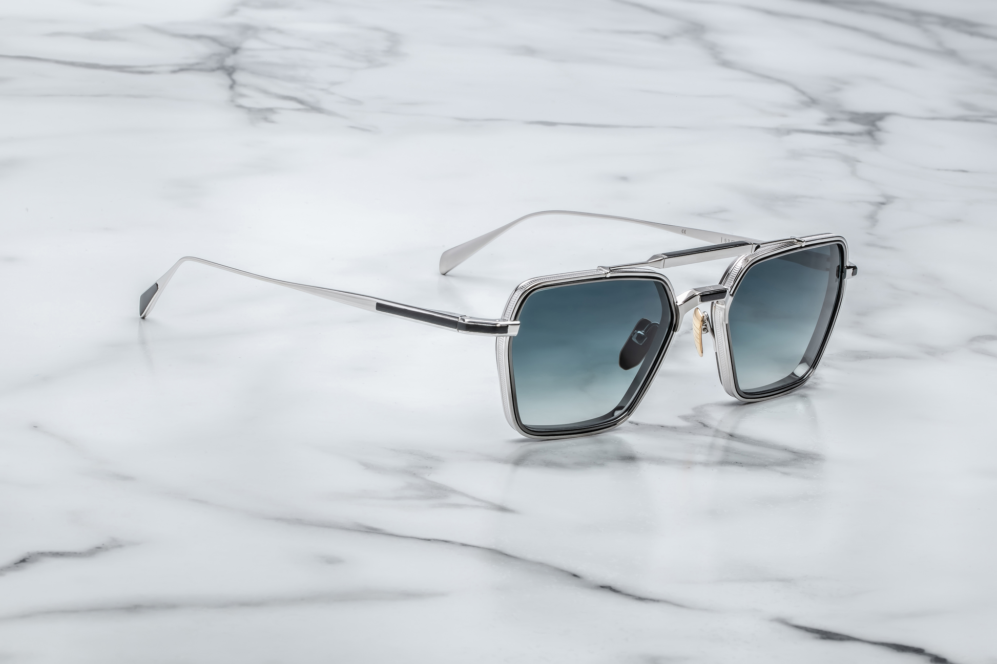 Side profile of Jacques Marie Mage Commodore in Pacific showing sculpted temples, signature metal hinges, and layered blue acetate, available at WINK Optometrists.