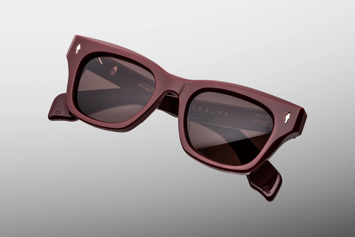  Top-down view of the Jacques Marie Mage Dealan Bordeaux Empire sunglasses, emphasizing the substantial 10mm thickness of the front block acetate profile. From above, the dual-laminated construction of the temples is fully visible, highlighting the pristine parallel alignment of the exposed internal silver wire cores and heavy-duty 7-barrel hinges. Available at WINK Optometrists.