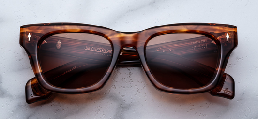 Jacques Marie Mage Dealan sunglasses in Bourbon front view – bold square amber tortoiseshell acetate frame with tinted lenses and signature arrowhead rivets – available at Wink Optometrists