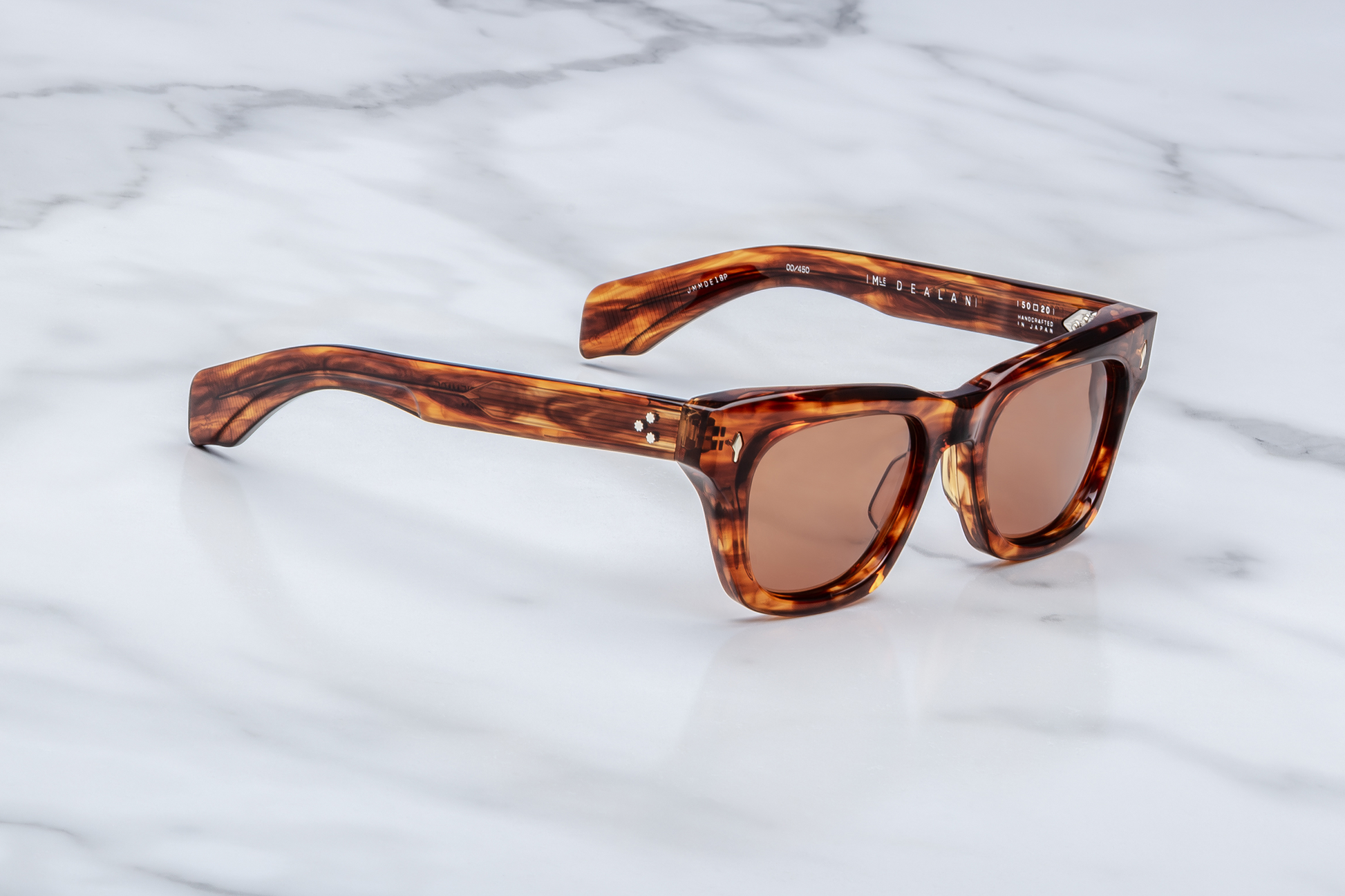 Jacques Marie Mage Dealan Bourbon sunglasses three quarter angle highlighting sculpted amber tortoiseshell acetate frame, thick temples and luxury craftsmanship – available at Wink Optometrists