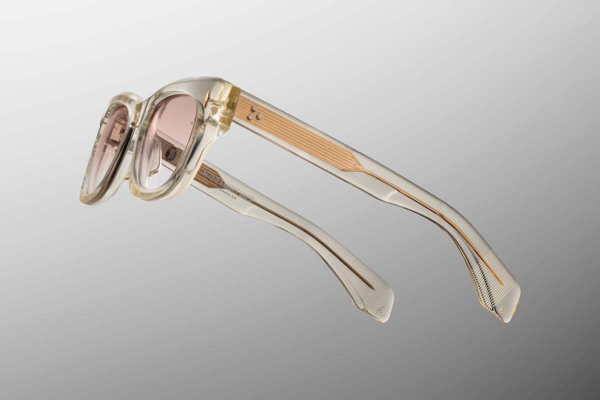 Side profile view of the Jacques Marie Mage Dealan from the Photochromic Collection in Halo. The focus is on the thick, sculptural paddle temple arms crafted from Polished Brut beige acetate. A premium, light-gold tension-secured custom 7-barrel hinge seamlessly anchors the side arms to the translucent front frame face. Available at WINK Optometrists.